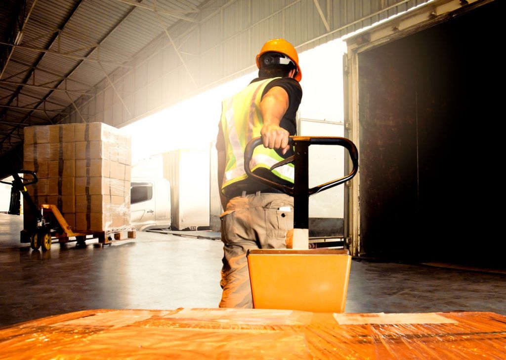 Warehouse Worker Unloading Product