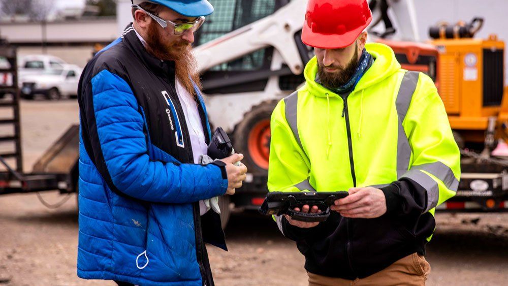 construction crew use tablet at construction site