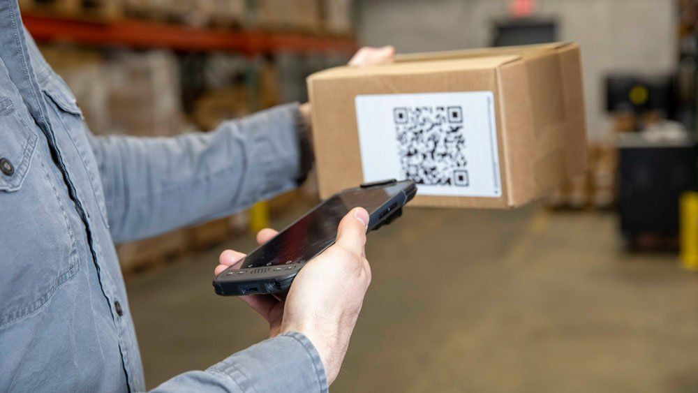 scanning box QR code with mobile computer in warehouse