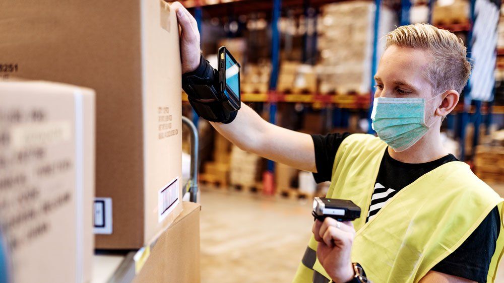 worker wearing mask uses ring scanner and wearable mobile computer