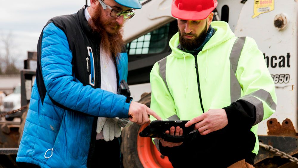 workers in front of truck using Sonim RS80 Rugged Tablet 