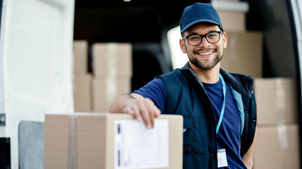 delivery worker standing near boxes and packages