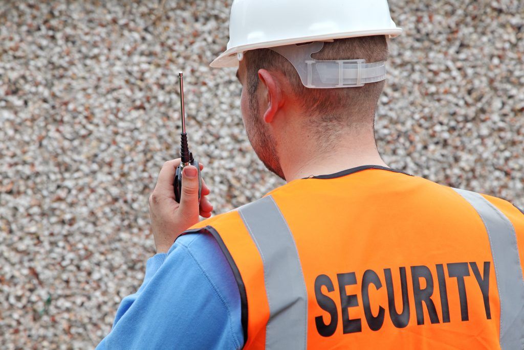 security guard at site with rugged communication device