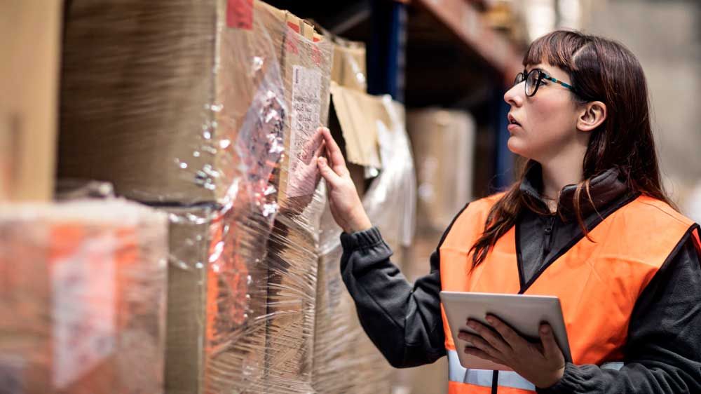 woman using tablet in warehouse