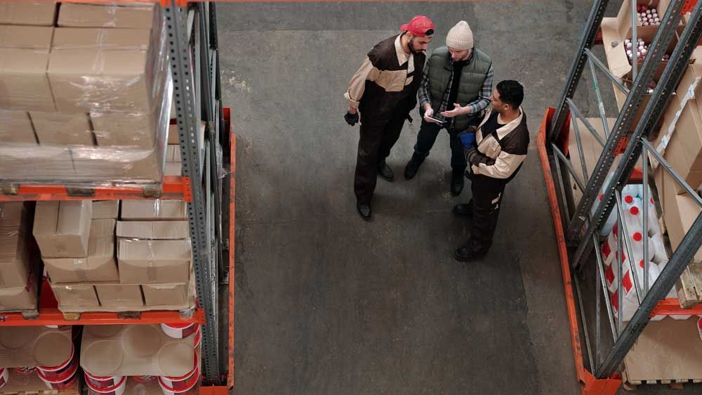 birds-eye of warehouse with workers in discussion