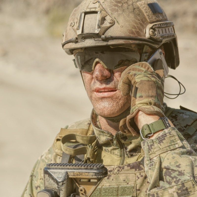 American Military Soldier Talking on Mobile Phone in the Field
