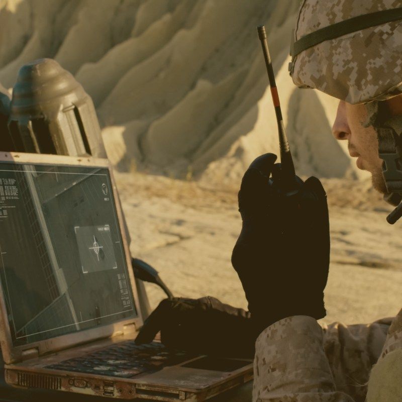 Soldier communicating from the field with rugged military laptop