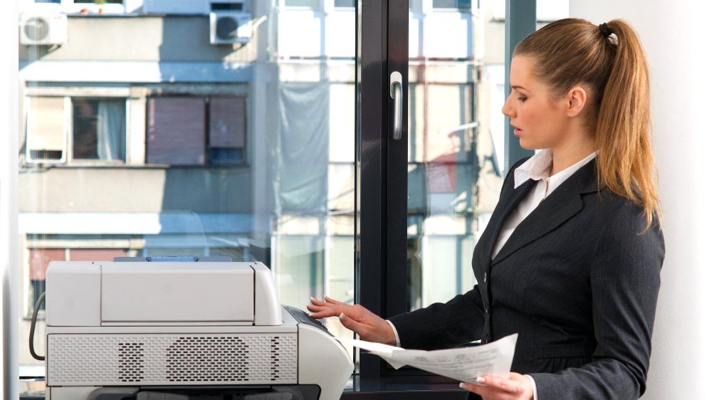 business woman working on printer