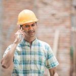 construction worker calling someone using a mobile phone