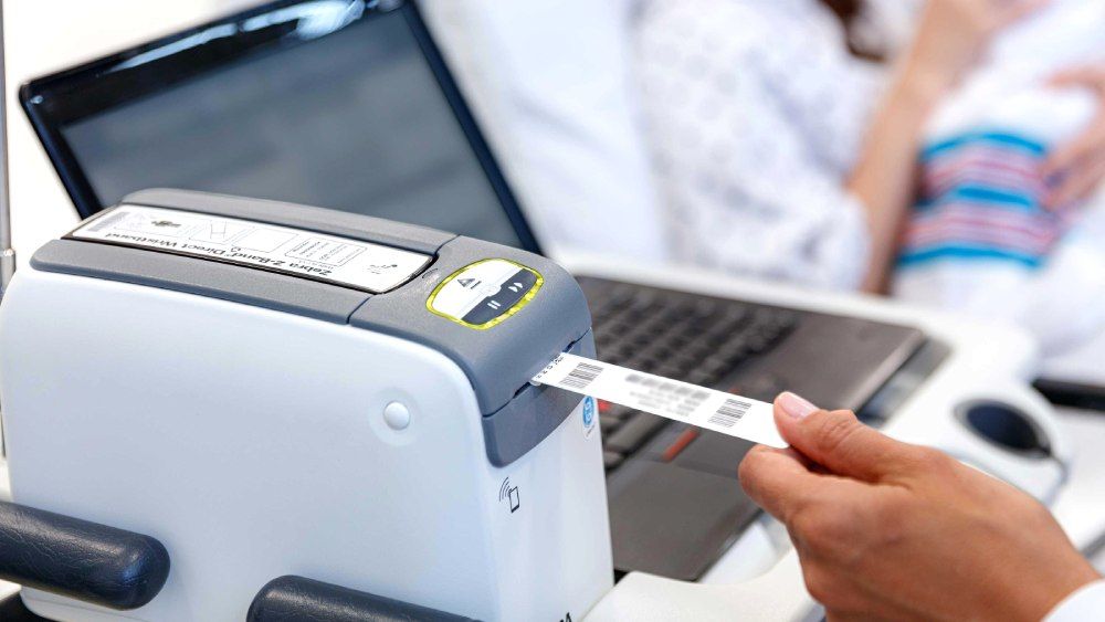 Zebra ZD510-HC wristband printer producing a printed barcode