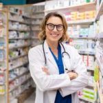 female doctor is standing inside the pharmacy